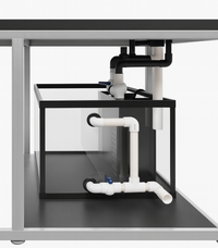 Underneath view of an aquarium sump with plumbing and electrical components.